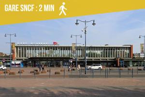 a large building with people walking in front of it at Jungle Suite - Sauna et Relaxation in Arras