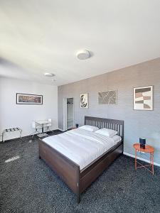 a bedroom with a large bed and a table at Keyless Hotel - Van Gaver in Brussels