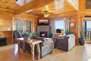 a living room with a couch and a fireplace at Smoky Mountain Bliss by Beyond Expectations in Sevierville