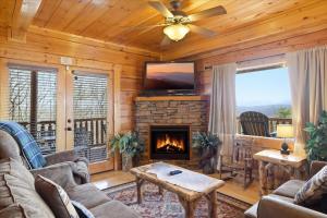 a living room with a fireplace and a tv at Smoky Mountain Bliss by Beyond Expectations in Sevierville +40 photos