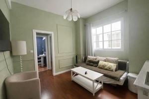 a living room with a couch and a table at Apartamentos Málaga centro in Málaga