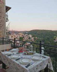 a table with plates of food on top of a balcony at GLEDKA Apartament in Veliko Tŭrnovo