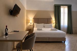 a bedroom with a bed and a table and a desk at Boboli Living in Florence