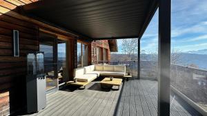 a living room with a couch on a deck at Bergidylle Winkler in Steindorf am Ossiacher See