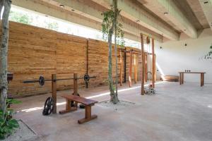 a room with a wooden wall and a bench at Limas in Tulum
