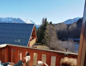 a person taking a picture from a balcony of a cabin at Dans les mélèzes in Saint-Pancrace