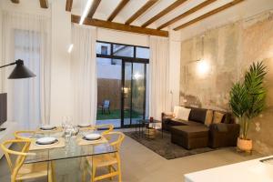 a living room with a glass table and a couch at Can Turia in Valencia +12 photos