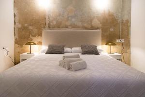 a bedroom with a large bed with two towels on it at Can Turia in Valencia