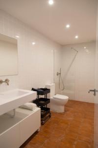 a bathroom with a toilet and a sink and a shower at Can Turia in Valencia