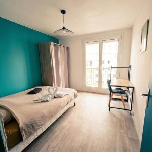 a bedroom with a bed with a chair and a desk at L'Atelier Eiffel Moderne & confortable in Saint-Brieuc