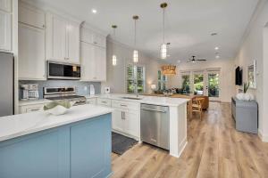 a large kitchen with white cabinets and a kitchen island at Seafarer Lodge South in Jekyll Island