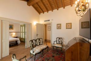 a living room with two chairs and a bed at Villa Simonetta in Parma +40 photos