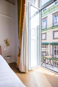 a bedroom with a large window and a bed at Themis Toledo - Private Spa Apartment in Naples