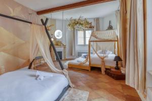 a bedroom with two beds and a canopy bed at La Planète 612 - Vue Capitole in Toulouse