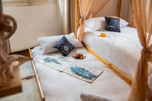 a room with two beds and a table at La Planète 612 - Vue Capitole in Toulouse +32 photos