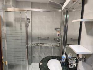 a bathroom with a shower and a sink at Piso Céntrico Nati Con Parking Incluído in O Grove