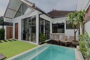 an image of a house with a swimming pool at Casa Leone Villa Canggu by Summerhouse Bali in Canggu
