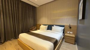 a bedroom with a large bed in a room at Kratos Lifestyle in Surat