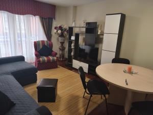 a living room with a couch and a table at Piso Céntrico Nati Con Parking Incluído in O Grove +15 photos