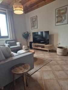 a living room with a couch and a flat screen tv at Escuelas de collía D AT-1537-AS in Arriondas