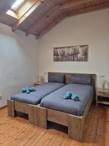 two beds in a room with two blue pillows at Escuelas de collía D AT-1537-AS in Arriondas