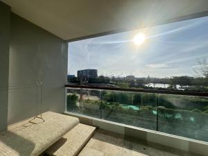a room with a large window with a view at Boat Avenue Apartment in Bang Tao Beach
