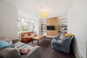 a living room with two couches and a tv at Breakwater Hostel in Newquay