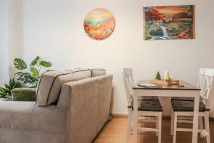 a living room with a couch and a table at Jolie Maison in Châtillon