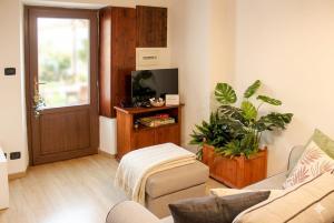 a living room with a couch and a tv at Jolie Maison in Châtillon