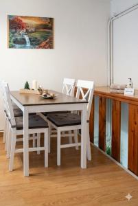a white dining table and chairs in a room at Jolie Maison in Châtillon +5 photos