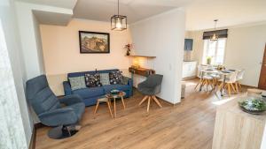 a living room with a couch and chairs and a table at Erasmus 1901 Apartments in Trassem