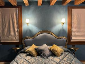 a bedroom with a bed with pillows on it at NEW OPENING San Marco Secret 4343 in Venice