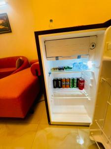 an open refrigerator with drinks in it in a room at Cafe Green Valley in Rangpur