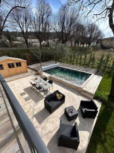 an overhead view of a pool with chairs and a table at Les Miracles du Ventoux in Malaucène
