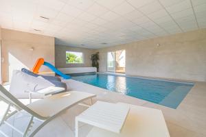 a swimming pool with a slide in a house at LA VILLA PALOMA in Crécy-la-Chapelle