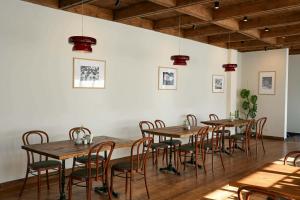 a dining room with wooden tables and chairs at Lasiim in Mestia