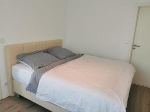 a bed with two pillows on it in a bedroom at 3 Ferienwohnungen am Teutoburger Wald in Natrup Hagen