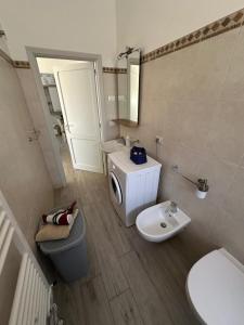 a small bathroom with a toilet and a sink at Casa Punta d'Oro in Faccia di Trippa +26 photos