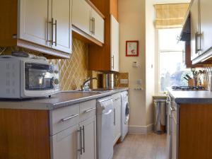 a kitchen with a sink and a microwave at Fell View in Ambleside