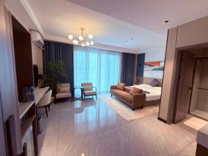 a hotel room with a bed and a living room at Hotel Eden - 24 Novembre in Kinshasa