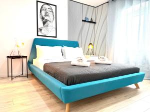 a blue bed with two towels on it in a bedroom at Apartments Nona in Pula +65 photos