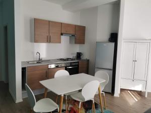 a small kitchen with a white table and chairs at 3 Ferienwohnungen am Teutoburger Wald in Natrup Hagen +18 photos