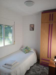 a bedroom with a bed and a dresser and a window at L'Hortet de Can Serra in Xerta +14 photos