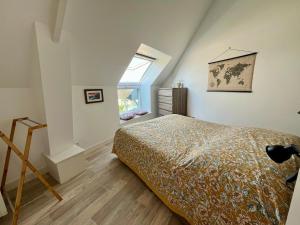 a bedroom with a bed and a window at L'Erable - Maison vue mer in Donville-les-Bains