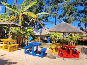 a group of tables and chairs on the beach at Beach Island Graskop in Graskop