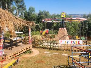 a playground with a play park with a carousel at Beach Island Graskop in Graskop +13 photos