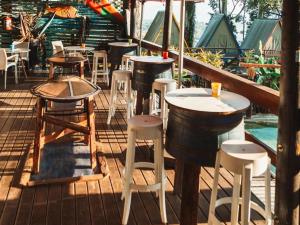 a row of bar stools and tables on a deck at Beach Island Graskop in Graskop