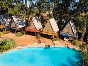 a group of tents sitting next to a swimming pool at Beach Island Graskop in Graskop