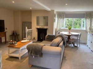 a living room with a couch and a table at The Studio Gressingham in Hornby