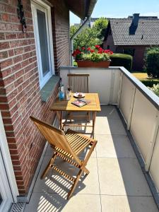 a wooden table and chairs on a small patio at Ferienwohnungen Mamat in Haltern +30 photos